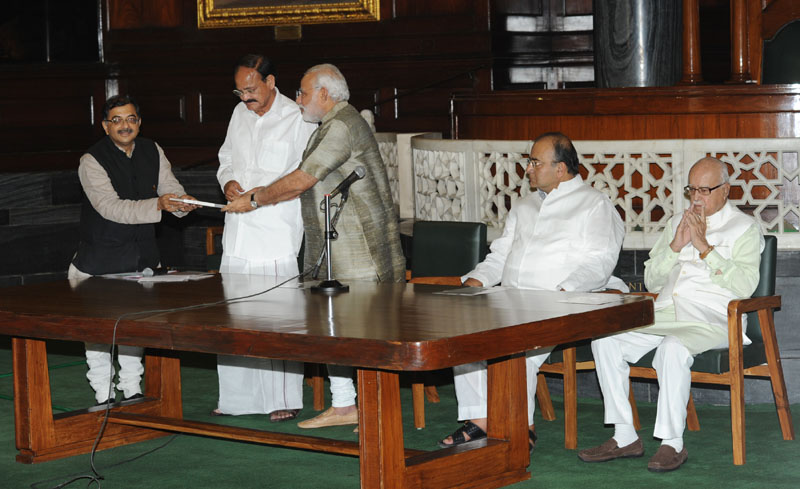 Shri Tarun Vijay presents book to PM