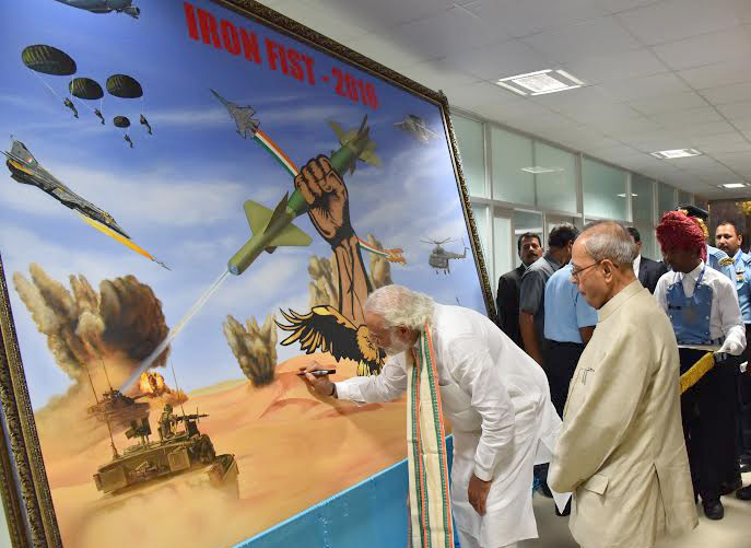 The Prime Minister, Shri Narendra Modi signing a painting at IAF Fire Power Demonstration 'IRON FIST 2016', at Pokhran, Rajasthan on March 18, 2016.