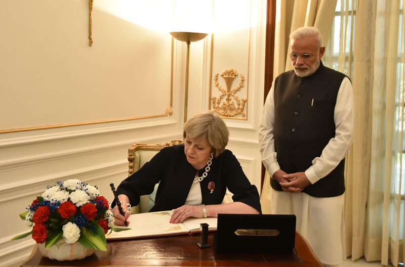 The Prime Minister of United Kingdom, Ms. Theresa May signing the visitor's book, at Hyderabad House, in New Delhi on November 07, 2016. 