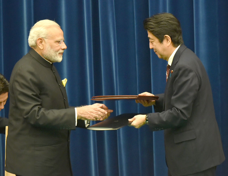 The Prime Minister, Shri Narendra Modi and the Prime Minister of Japan, Mr. Shinzo Abe exchanging after signing the joint statement, at Kantei, in Tokyo, Japan on November 11, 2016.