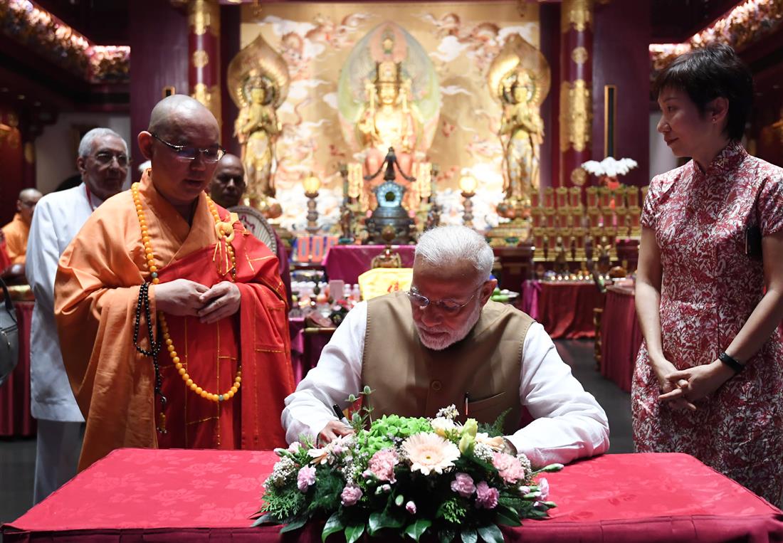 The Prime Minister, Shri Narendra Modi signing the visitors’ book, during his visit to the Buddha Tooth Relic Temple and Museum, in Singapore on June 02, 2018.