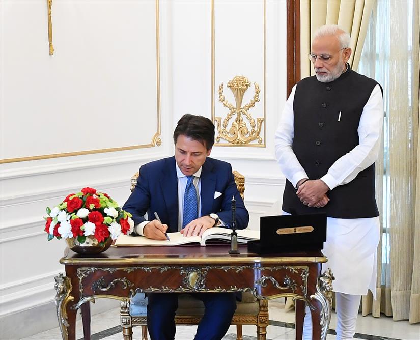 The Prime Minister of Italy, Mr. Giuseppe Conte signing the visitors’ book, at Hyderabad House, in New Delhi on October 30, 2018.