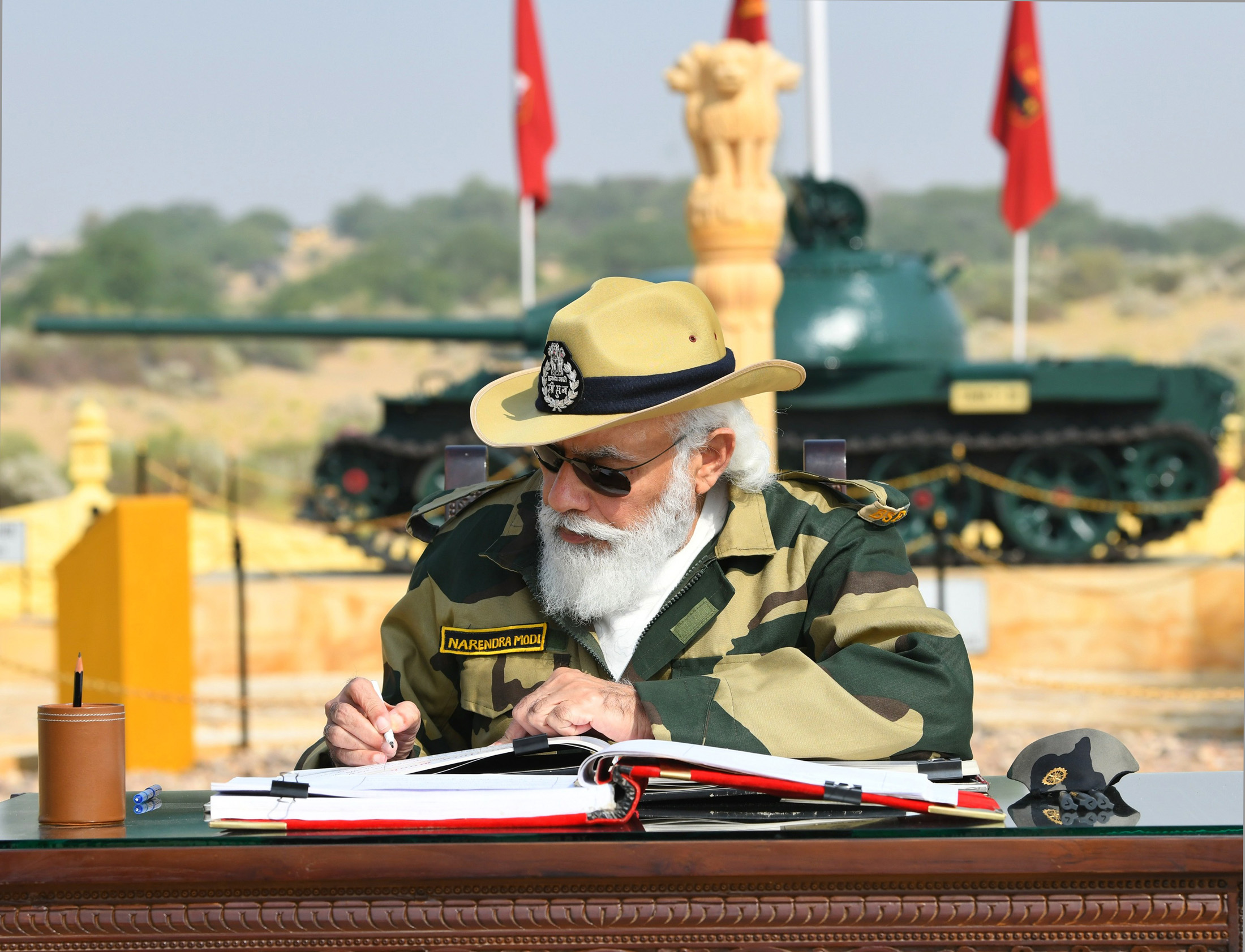 The Prime Minister, Shri Narendra Modi signing the visitors book, at Longewala in Jaisalmer, Rajasthan on November 14, 2020.