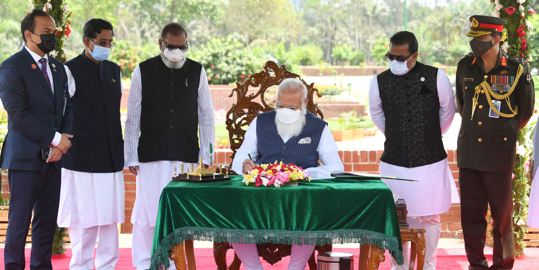 The Prime Minister, Shri Narendra Modi signing the visitors book at the National Martyrs Memorial, Savar, in Dhaka, Bangladesh on March 26, 2021.