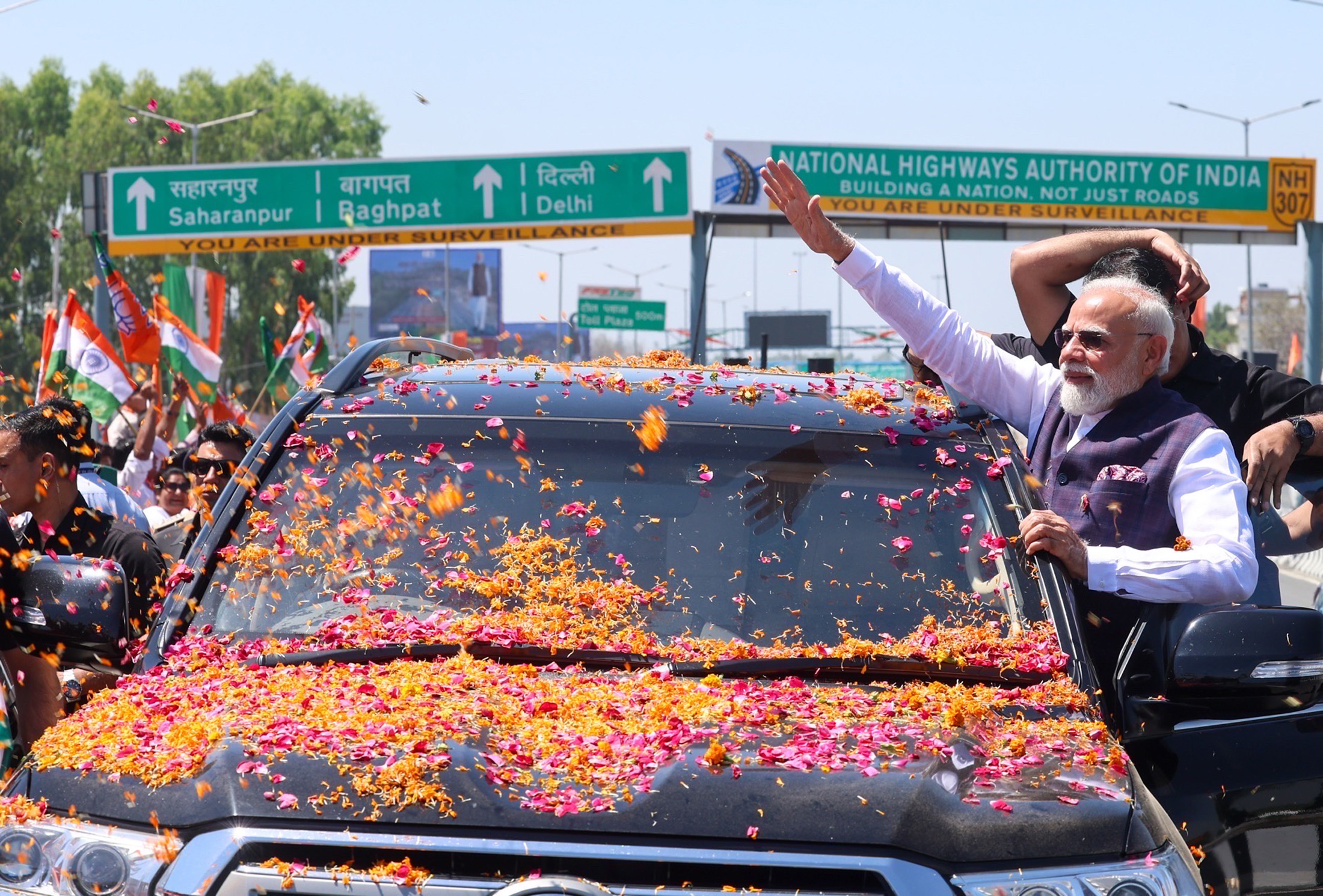 PM receives warm welcome by people on his arrival at Saharanpur, in Uttar Pradesh on April 14, 2026.